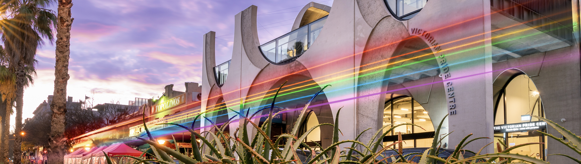Pride Centre at dusk with rainbow lighting