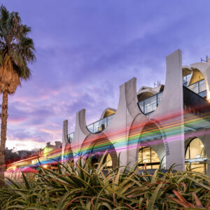 Out the front of VPC, with a string of rainbow lights illuminated across the building on a straight horizontal line