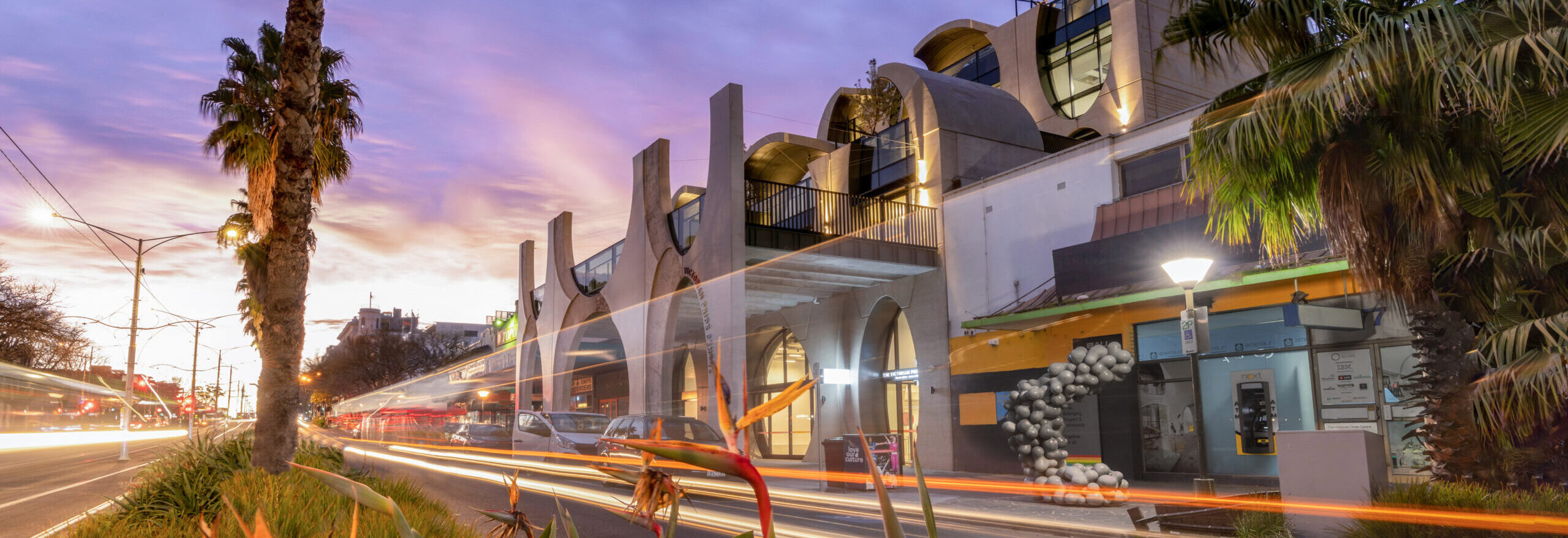 Outside of the VPC with a string of rainbow lights on Fitzroy St